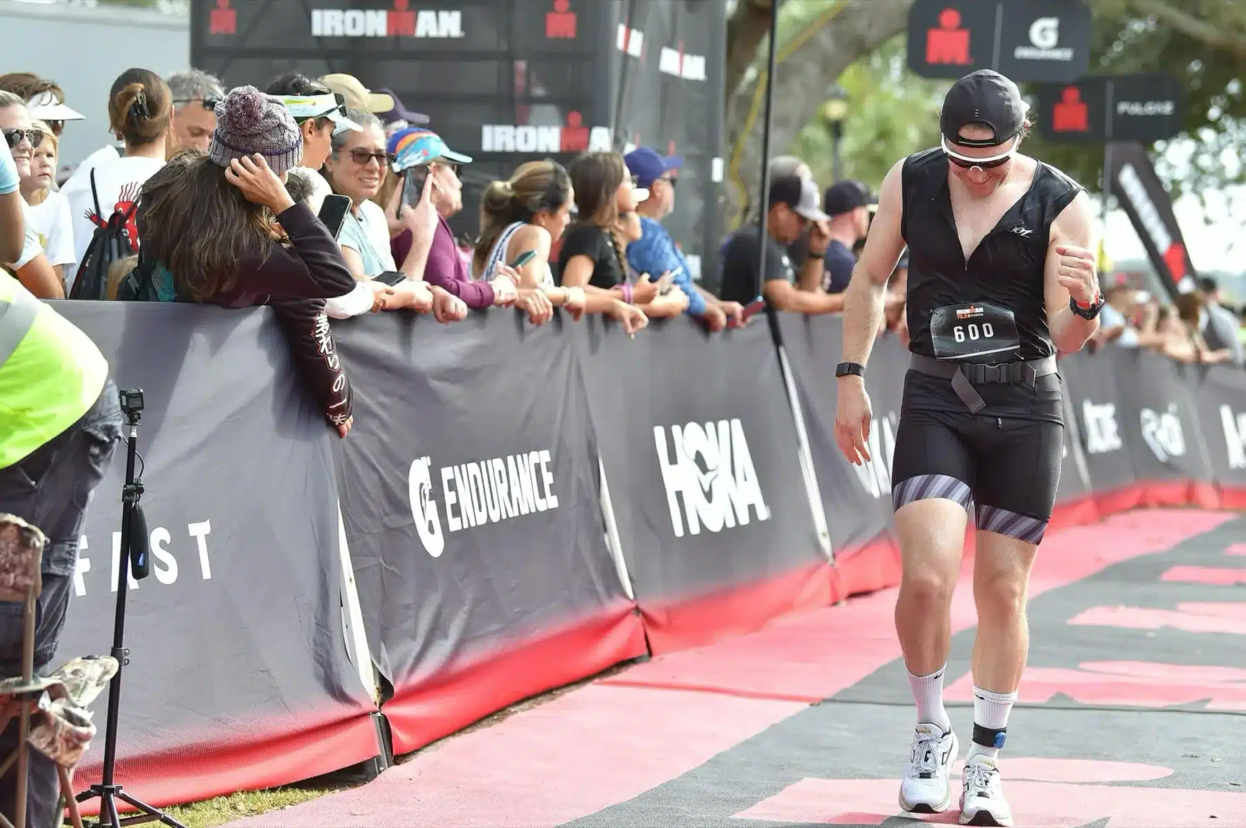 Galen McNaughton running toward a triathlon finish